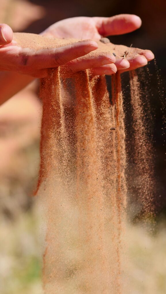 A serene moment captured as sand flows gently through human hands, symbolizing time and zen.